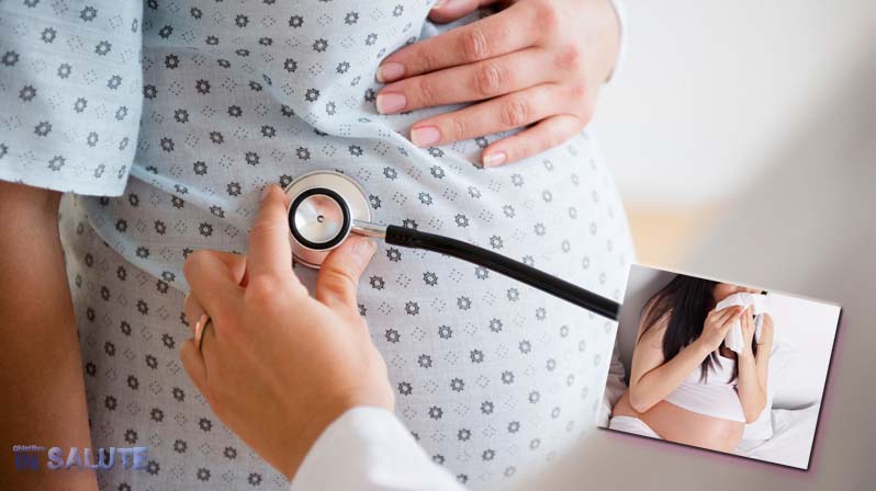 Un medico visita con uno stetoscopio una donna incinta